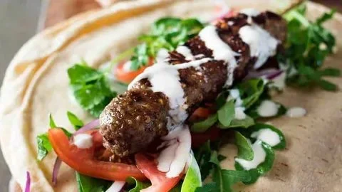 Authentic Turkish lamb kofta kebabs served with herbs and spices.