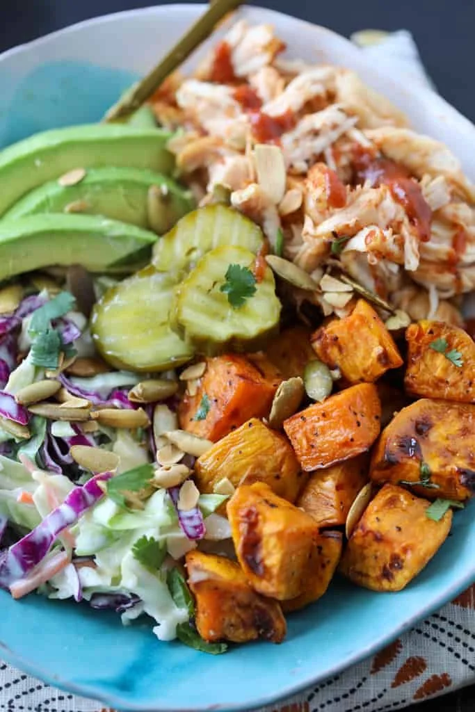 BBQ chicken rice bowl with colorful vegetables and sauce
