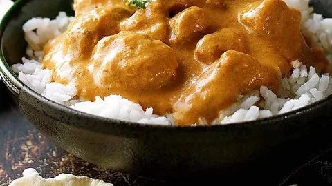 Delicious Butter Chicken served with rice and naan bread