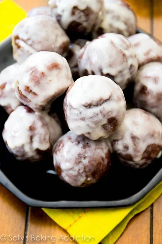 Chocolate glazed donut bites with a shiny chocolate coating