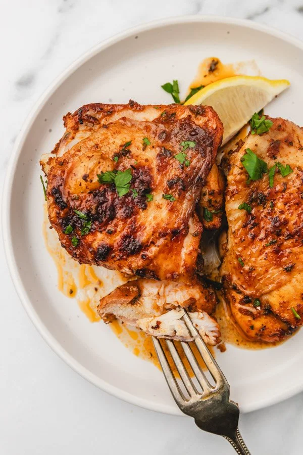 Plate of Crispy Old Bay Chicken Thighs with garnishes
