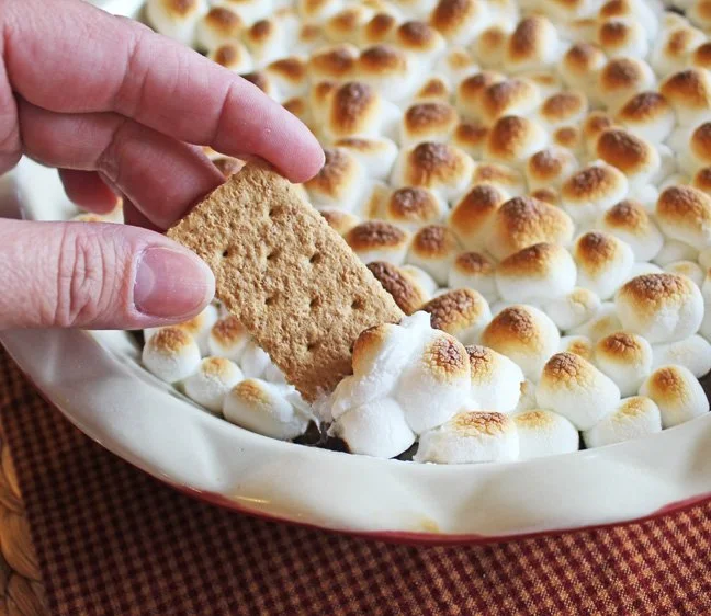 Delicious easy Smore Dip served in a bowl with graham crackers and marshmallows