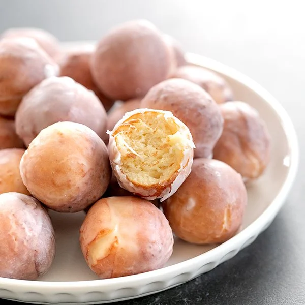 A plate of glazed gluten-free donut holes enticingly served for dessert.