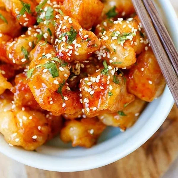 Delicious glazed sweet chili chicken served on a plate with garnish
