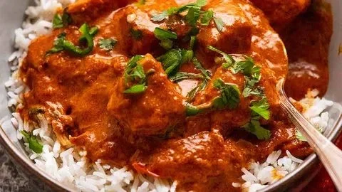 Delicious Goan Fish Curry served with rice and garnished with fresh herbs