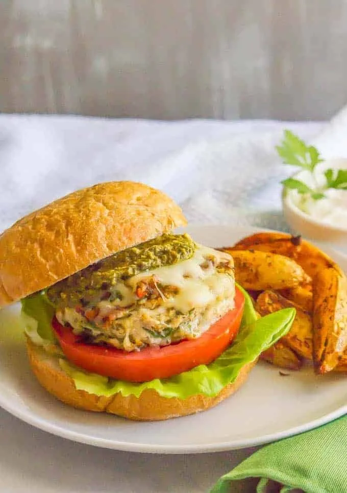 Delicious herbed chicken sliders with spinach on a wooden platter