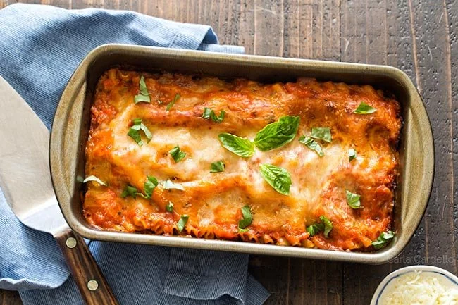 Savory lasagna for two served with fresh ingredients and layers of flavor.