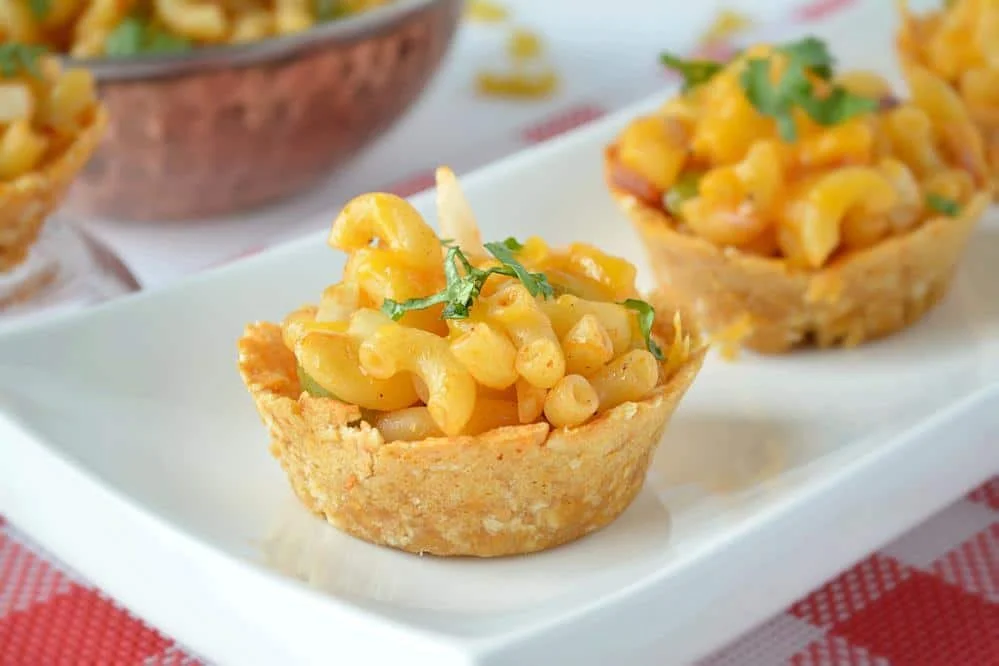 Colorful macaroni salad served in cups, ideal for parties and gatherings.