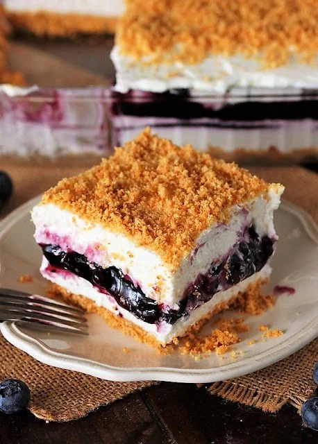 No-bake blueberry yum bars displayed on a rustic wooden table.