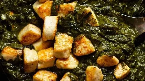 Bowl of Palak Paneer Indian spinach curry with fresh herbs and spices