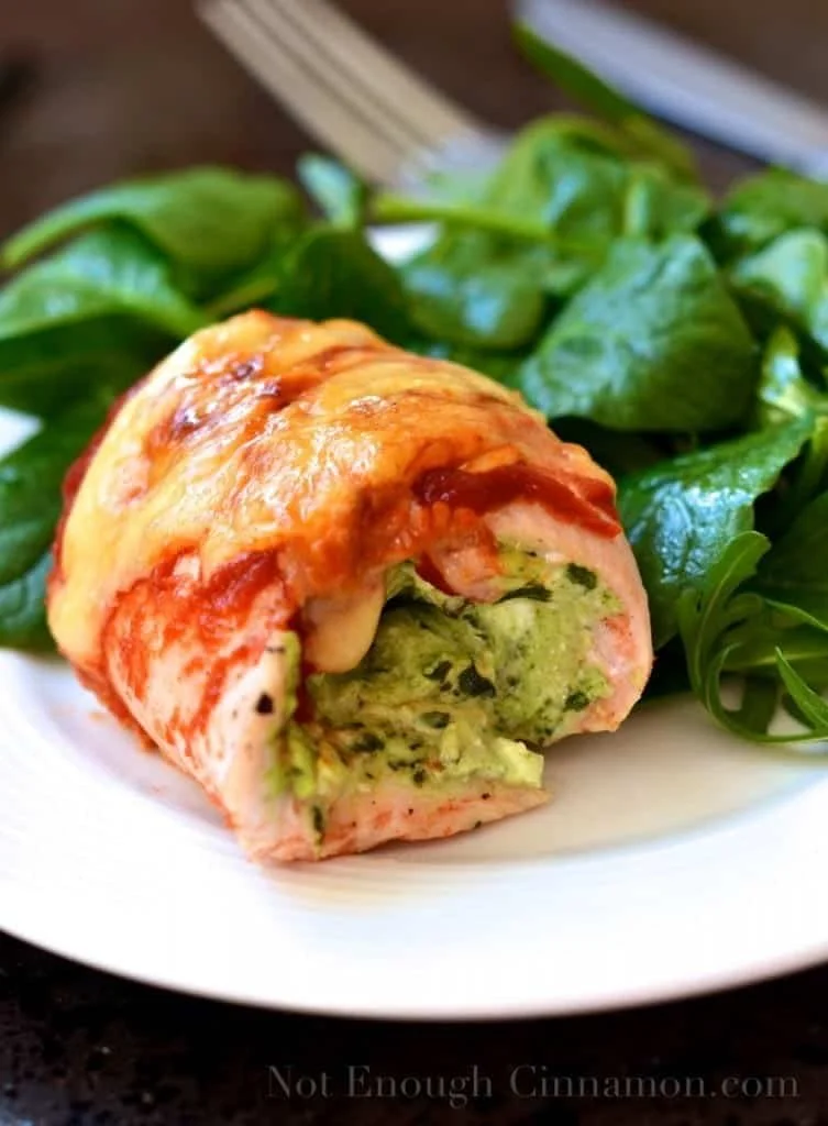 Delicious Pesto Cream Cheese Chicken Rollatini plated with fresh herbs