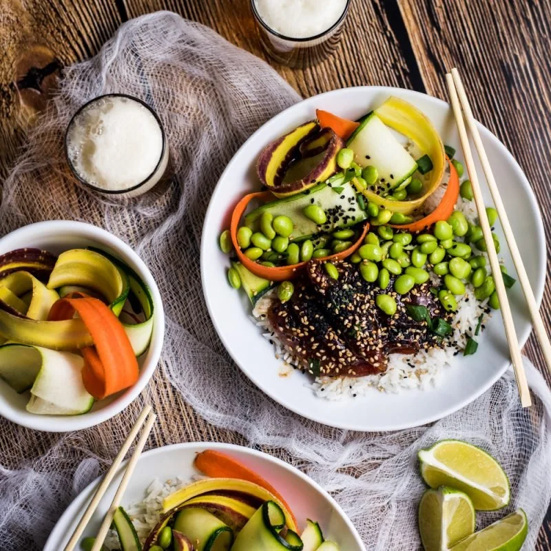 Delicious Sesame Ginger Ahi Poke Bowl garnished with vegetables and sesame seeds