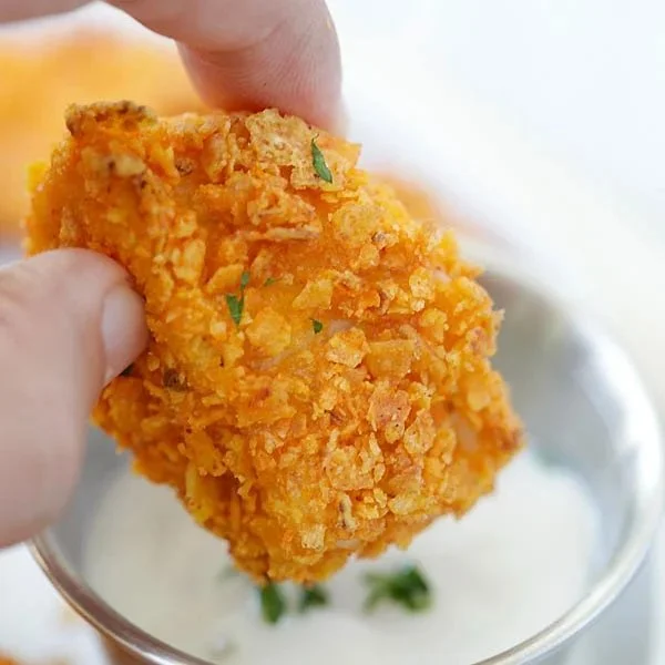 Tortilla chip crusted chicken bites served with dipping sauce