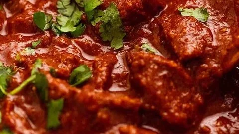 Delicious bowl of vindaloo curry with spices and herbs